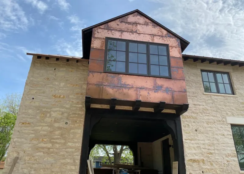 Copper metal panel facade on a stone building for Metal Roof Coating in Big Spring